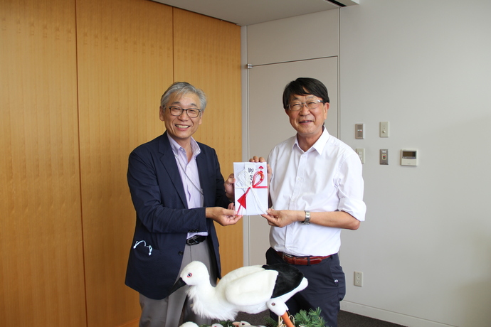 写真：中貝市長が太田垣さんから目録を受け取る様子