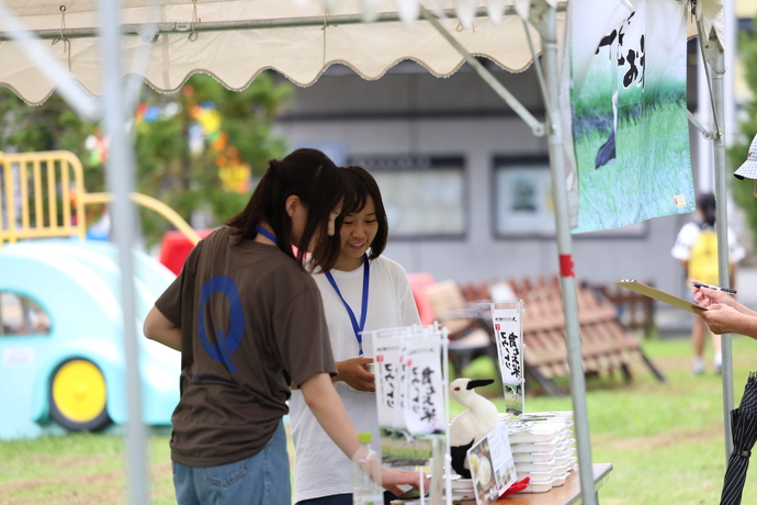 写真：コウノトリ米をPRする学生